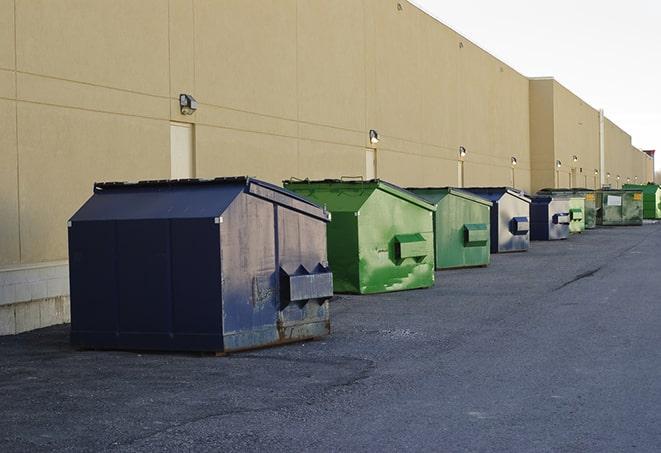 a group of dumpsters lined up along the street ready for use in a large-scale construction project in Excelsior, MN